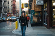 © Lauren Naefe/Stocksy - Young woman walking on street in the city