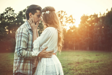 Wall Mural - Young lovely couple at sunset