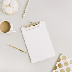 Wall Mural - Modern home office desk with clipboard, macaroons, pen, coffee mug on pastel background. Flat lay, top view lifestyle concept.