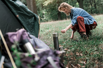 Wall Mural - Joyful young woman pitching a tent