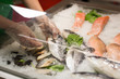 High Angle Still Life of Variety of Raw Fresh Fish Chilling on Bed of Cold Ice in Seafood Market Stall,Fresh seafood on ice in the showcase,Salmon on cooled market display,Supermarket, fish department