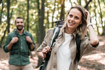 Wall Mural - Joyful tourists enjoying natural view in forest