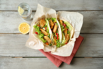 Sticker - Delicious fish tacos on wooden table