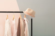 Apricot and beige clothes on hangers against trendy color background