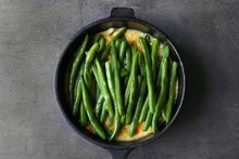 Frying Pan With Delicious Green Bean Casserole On Kitchen Table