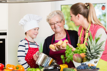 Family cooking in multigenerational household with son, mother, father and grandfather