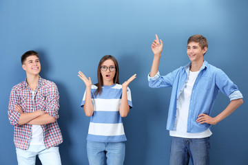 Wall Mural - Teenagers in casual clothes on color background