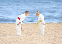 Little Children Performing Ritual Bow Prior To Practicing Karate Outdoors