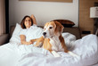 © Soloviova Liudmyla - Woman and her beagle dog meet morning in bed