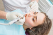 © SergeyCash - Dentist curing a female patient with drill, closeup.