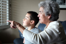 Hispanic Grandma With Grandson Pointing Out The Window