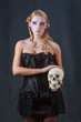 Beautiful blonde holding skull mystical concept