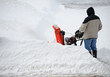 © nd700 - man operating snow blower to remove snow on driveway