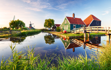 traditional dutch windmill near the canal. netherlands, landcape at sunset