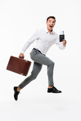 Wall Mural - Full length portrait of an excited man in white shirt