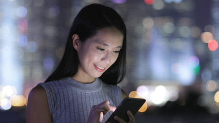 Poster - Woman use of mobile phone in Hong Kong city at night