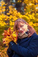 Portrait of  woman in an autumn park.