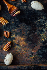 Poster - Pecan nut and wooden spoon on rustic table.