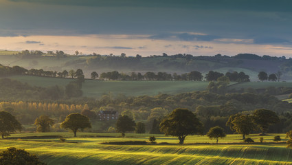 hazy sunrise over british countryside