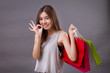 woman shopping with shopping bag and ok hand sign, good shopping experience concept