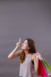 woman shopper with shopping bag pointing up