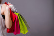 girl shopping concept, anonymous woman shopper holding shopping bag isolated