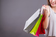girl shopping concept, anonymous woman shopper holding shopping bag isolated