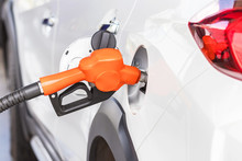 Orange Fuel Nozzle Refueling Gas Pump For The Car In Gas Service Station    