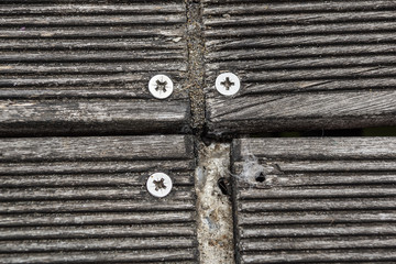 Close up of wooden jetty screws . wooden board for walk