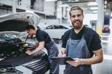 Wall Mural - Handsome auto service mechanics