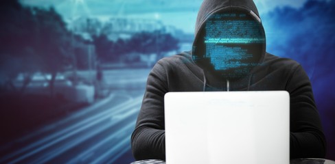 Poster - Composite image of hacker wearing black hood while using laptop