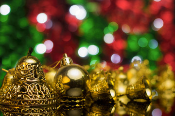 Wall Mural - Christmas decoration on a golden background. bokeh background and dark mirror floor.