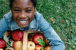© Gabriel (Gabi) Bucataru/Stocksy - Smiling black girl with apple basket