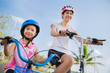 © torwaiphoto - Mother and daughter are cycling exercise