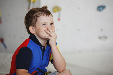 Child climbing on a high wall