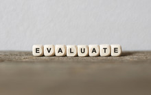 Word EVALUATE Made With Wood Building Blocks