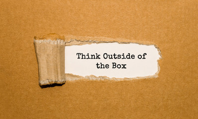 Wall Mural - The text Think Outside of the Box appearing behind torn brown paper
