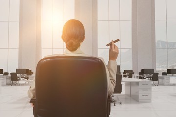 Poster - Composite image of rear view of female executive holding cigar