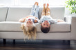 © Louis-Paul Photo - Pretty little girl and boy are lying on their backs on sofa, l