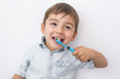 © Louis-Paul Photo - smiley boy cleans a teeth isolated on grey background
