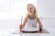 © Louis-Paul Photo - Little girl holding fork empty plate ready for food.