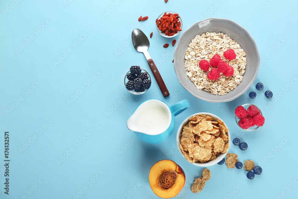 Nutritious oatmeal with berries on color background