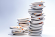 A Pile Of Dirty Dishes From A Restaurant On A White Background.
