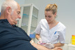 © auremar - Nurse taking blood from senior male patient