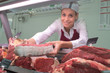 female butchers works at a supermarket