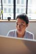 © Jacob Lund - Businesswoman working on computer at her office