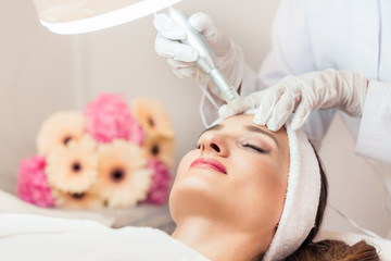 close-up of the face of a woman relaxing during non-surgical facelift treatment in a contemporary be
