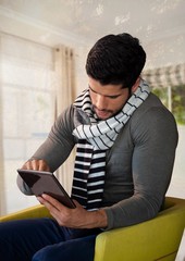 Wall Mural - Man in Autumn with tablet and scarf in chair at home