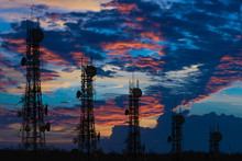 Silhouette Of The Antenna Of Cellular Cell Phone And Communication System Tower Arranged As A Bar Chart On Cloud And Blue Sky Background, Telecommunication Technology Concept.