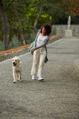 Wall Mural - Funny healthy lady running in the morning with her dog in park